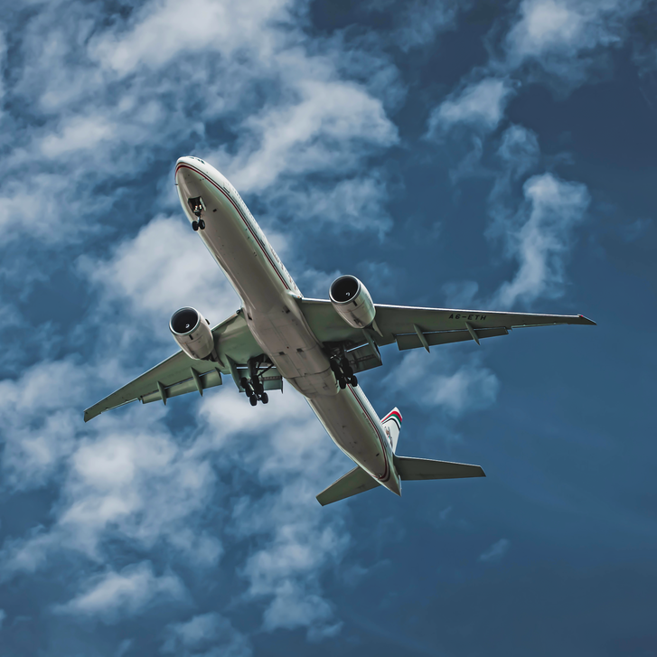 Flying Airplane Under Blue Sky and White Clouds